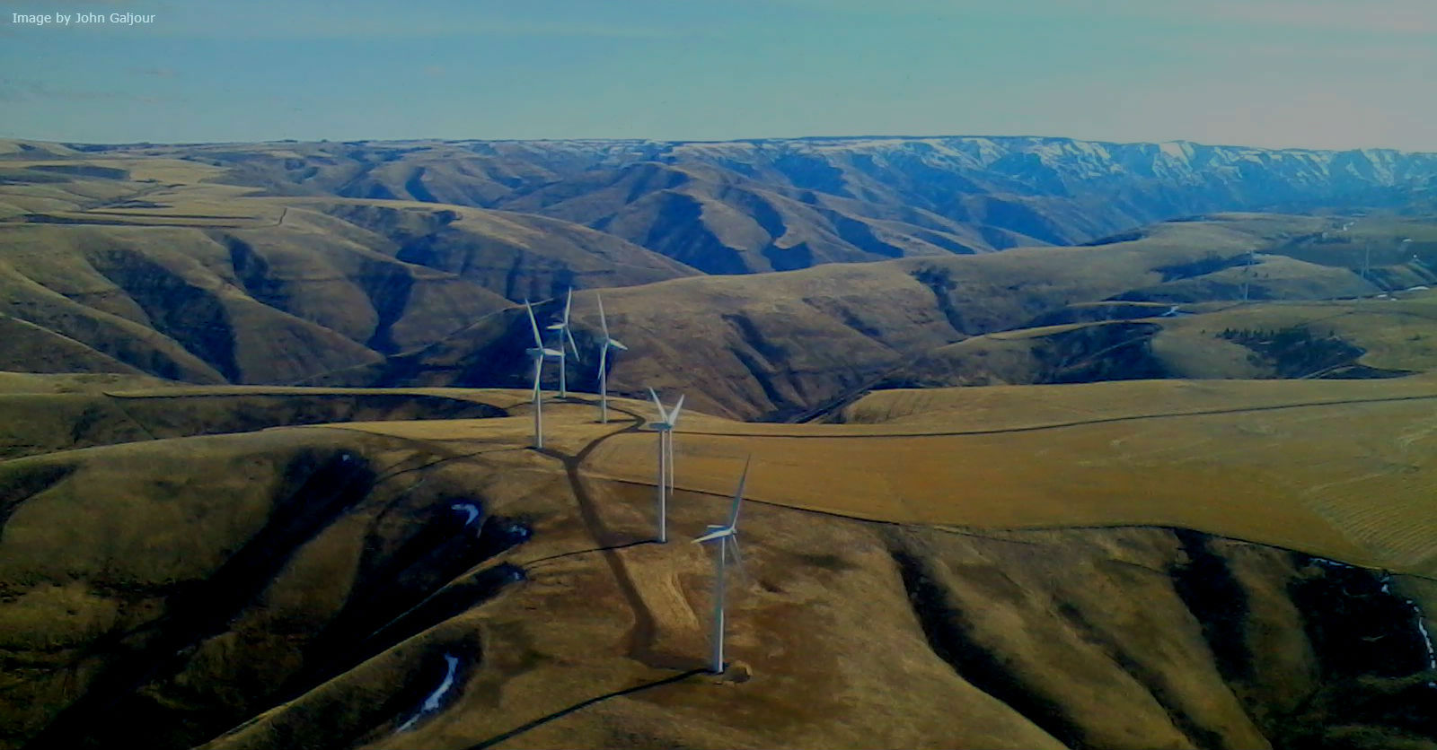 An arial photograph oh windmills on a hill.